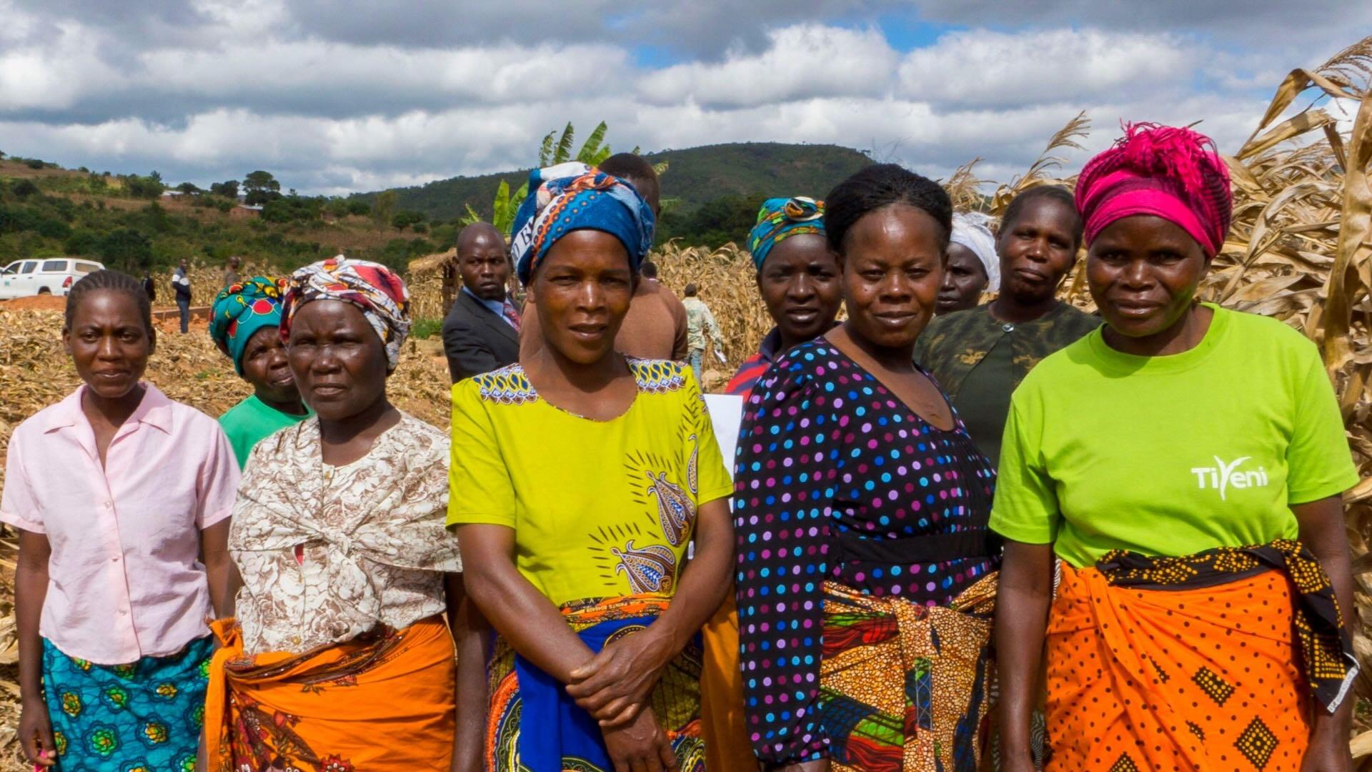 Group of Malawi women with maize in the background. 